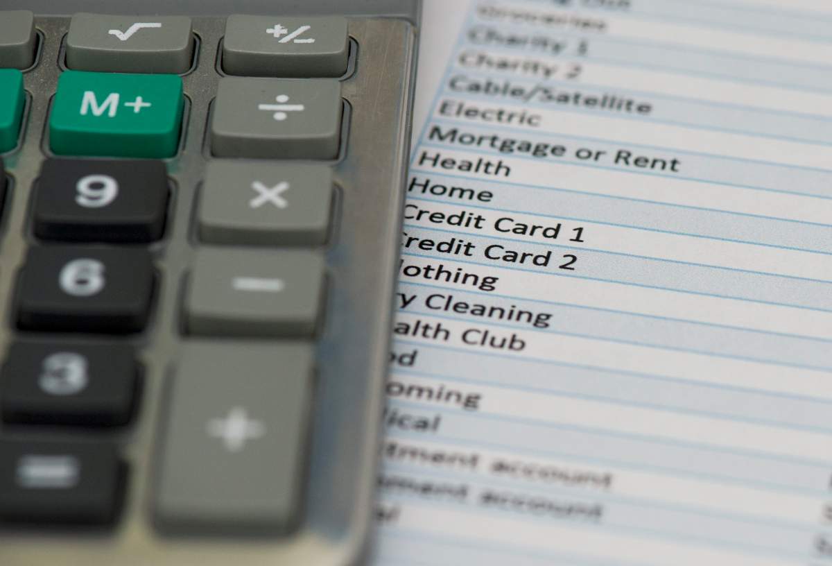 A calculator for household expenses and expense sheet are shown in Montreal, Thursday, June 23, 2016.