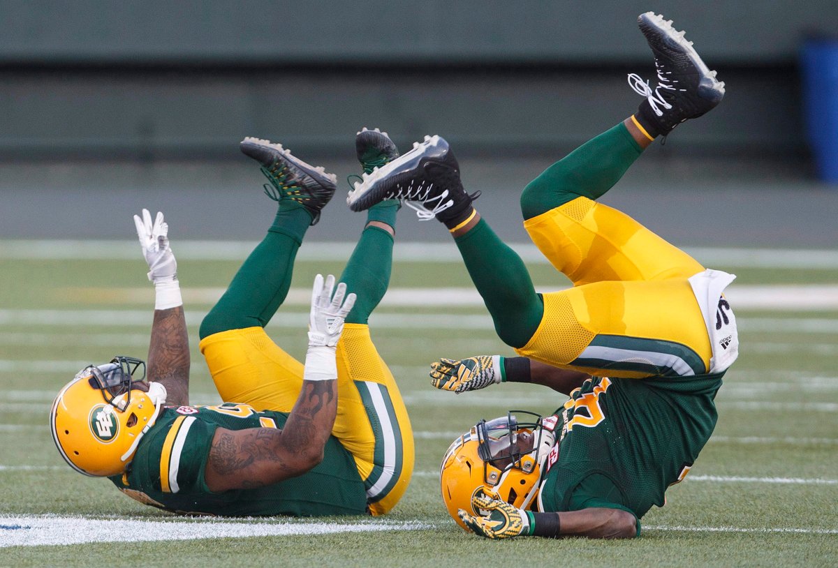 Edmonton Eskimos' Da'Quan Bowers (92) and Odell Willis (41) celebrate a tackle against the Ottawa Redblacks during first half CFL action in Edmonton, Alta., on Friday July 14, 2017. 