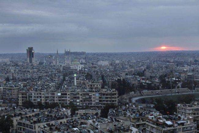 In this Jan. 18, 2018 photo, the sun rises over the city of Aleppo, Syria.