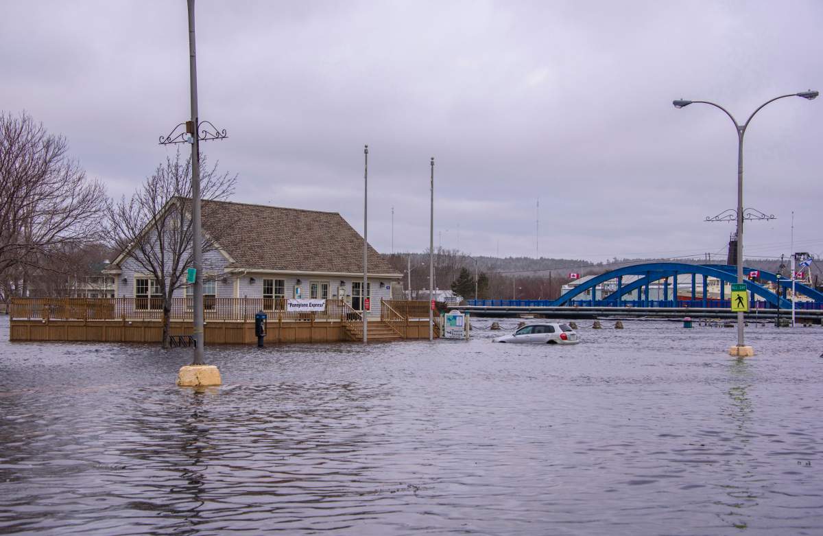 A car sits in sea water up to it’s wheel wells at a tourist bureau in Liverpool, Nova Scotia on Saturday March 3, 2018. After another weekend of storm surges battering Nova Scotia’s south shore, there’re rising concerns from some municipal politicians and citizens about the need for help adapting to climate change.