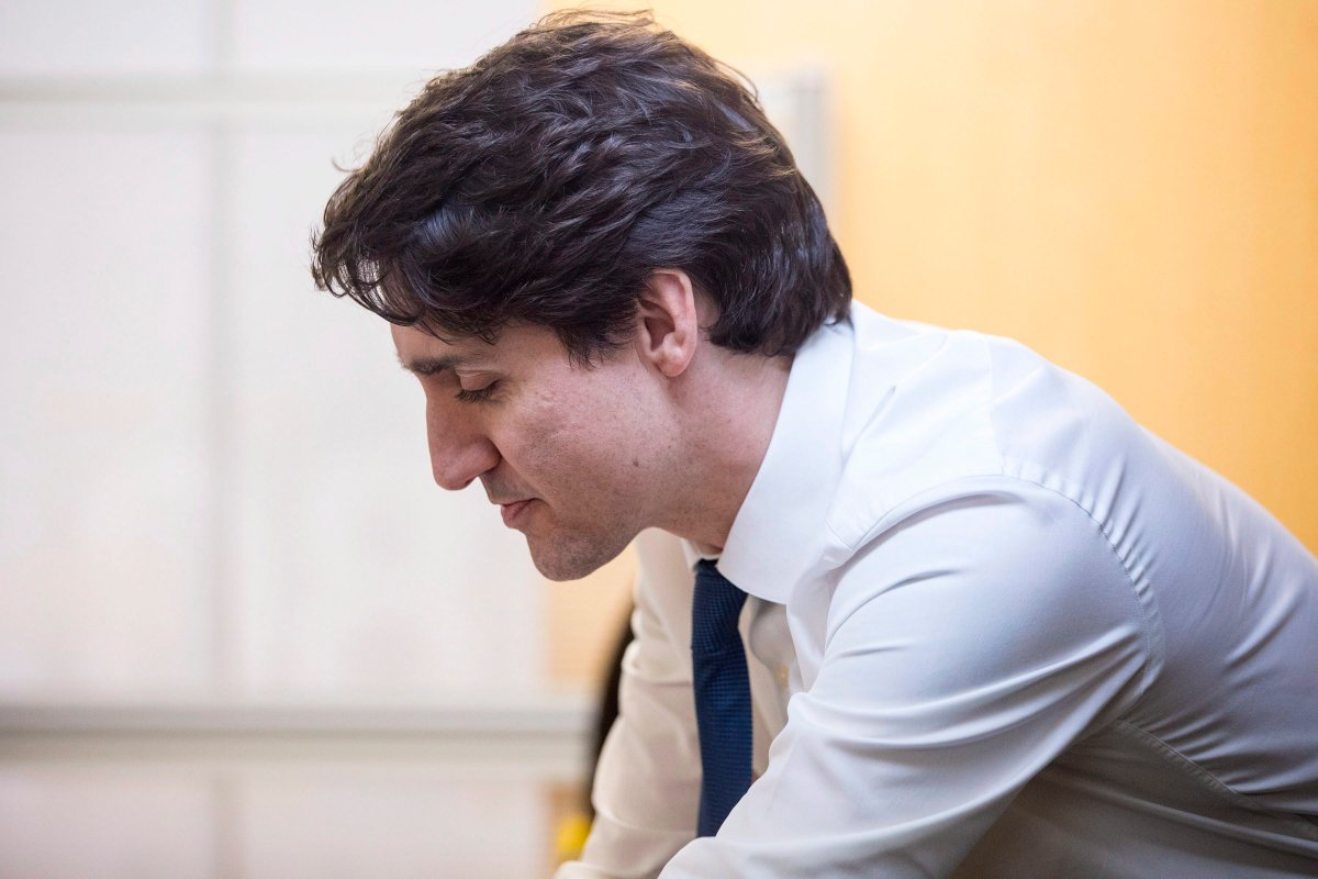 Prime Minister Justin Trudeau talks to clients and staff during a visit to the Employment Services Centre of WoodGreen Community Services in Toronto on Wednesday March 7, 2018. 