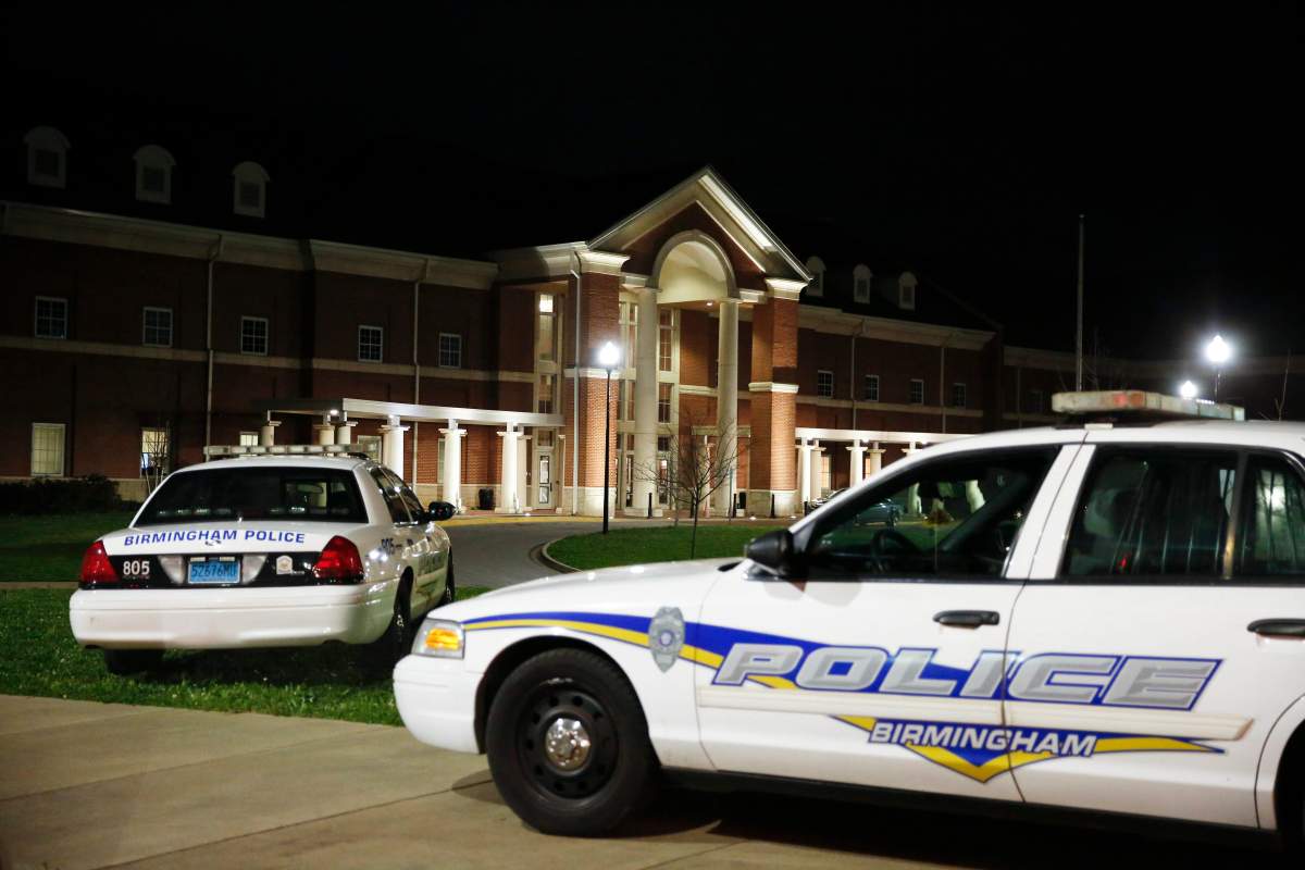 Huffman High School is seen behind Birmingham Police cars after at a shooting Wednesday, March 7, 2018, in Birmingham, Ala. 