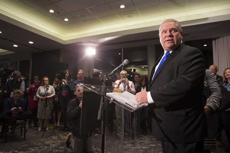 Doug Ford stands at the podium after being named as the newly elected leader of the Ontario Progressive Conservatives at the delayed Ontario PC Leadership announcement in Markham, Ont., on Saturday, March 10, 2018. 