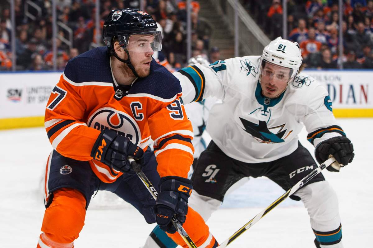 San Jose Sharks defenceman Justin Braun (61) chases Edmonton Oilers centre Connor McDavid (97) during second period NHL action in Edmonton, Alta., on Wednesday March 14, 2018.