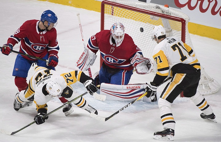 Pittsburgh Penguins right wing Patric Hornqvist (72) scores against Montreal Canadiens goaltender Antti Niemi (37) as Penguins centre Evgeni Malkin (71) and Canadiens defenceman Noah Juulsen (58) look for the rebound during third period NHL hockey action in Montreal, Thursday, March 15, 2018. 