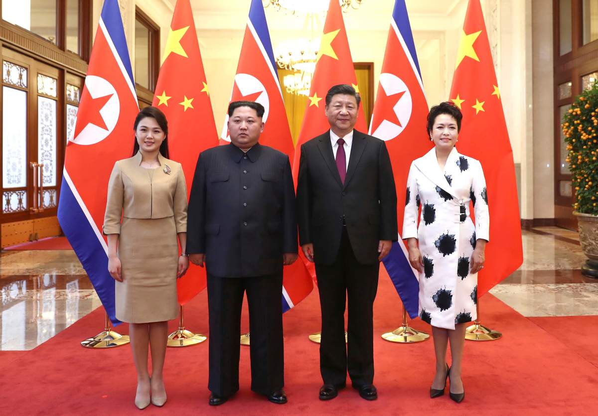 In this photo released Wednesday, March 28, 2018 by China’s Xinhua News Agency, Chinese President Xi Jinping, second from right, and his wife Peng Liyuan, right, and North Korean leader Kim Jong Un, second from left, and his wife Ri Sol Ju, left, pose for a photo at the Great Hall of the People in Beijing. The Chinese government confirmed Wednesday that North Korea’s reclusive leader Kim went to Beijing and met with Chinese President Xi in his first known trip to a foreign country since he took power in 2011. (Ju Peng/Xinhua via AP)