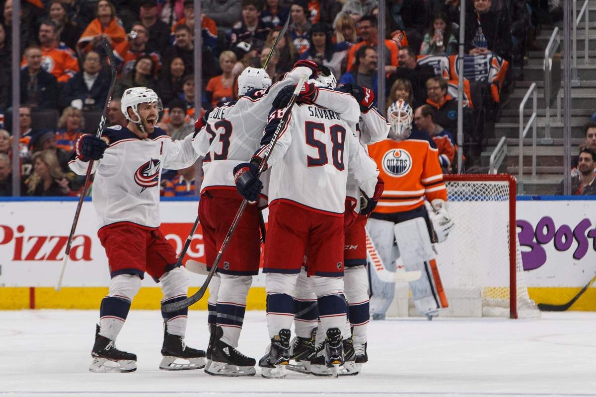 Columbus Blue Jackets players celebrate a goal as Edmonton Oilers goalie Cam Talbot (33) looks on during second period NHL action in Edmonton, Alta., on Tuesday March 27, 2018. 
