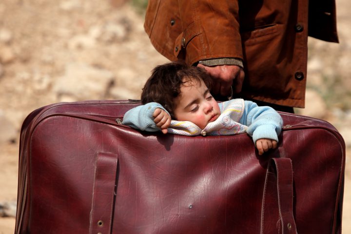 A child sleeps in a bag in the village of Beit Sawa, eastern Ghouta.