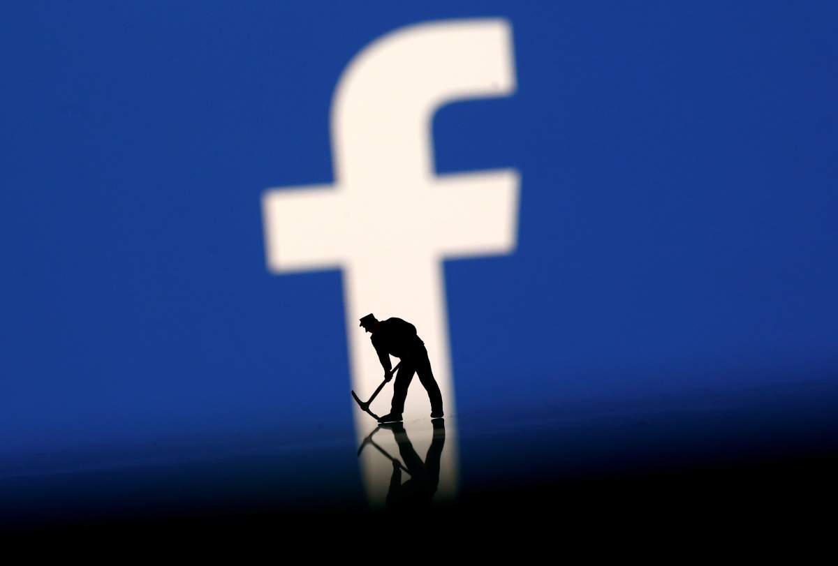 FILE PHOTO: A figurine is seen in front of the Facebook logo in this illustration taken, March 20, 2018. REUTERS/Dado Ruvic/File Photo.