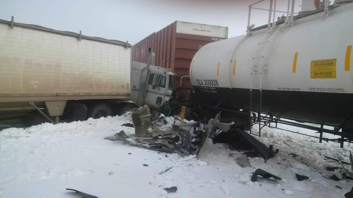 A semi truck hit a freight train on Highway 575 causing a minor derailment and highway closure on Wednesday morning. 