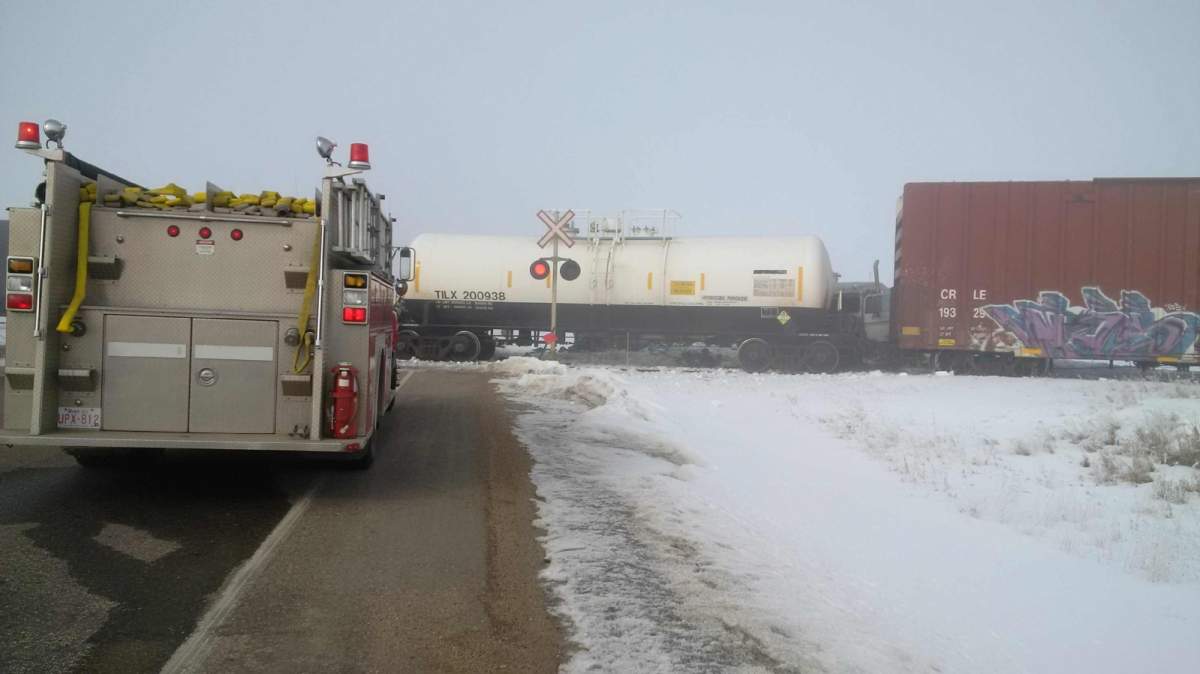 A semi truck hit a freight train on Highway 575 causing a minor derailment and highway closure on Wednesday morning.