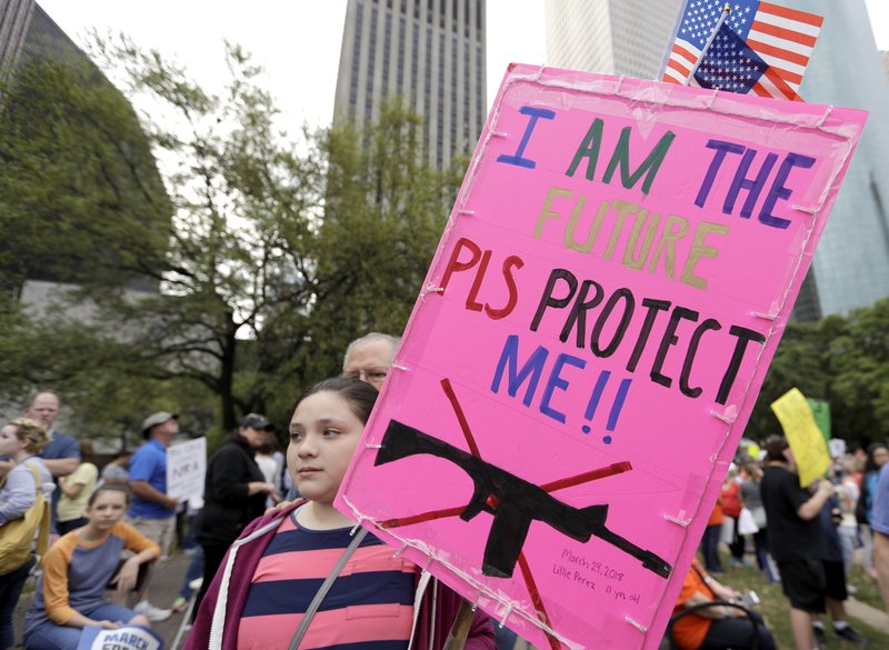 Lillie Perez, 11, holds a sign during a “March for Our Lives” protest for gun legislation and school safety Saturday, March 24, 2018, in Houston. Students and activists across the country planned events Saturday in conjunction with a Washington march spearheaded by teens from Marjory Stoneman Douglas High School in Parkland, Fla., where over a dozen people were killed in February. (AP Photo/David J. Phillip)