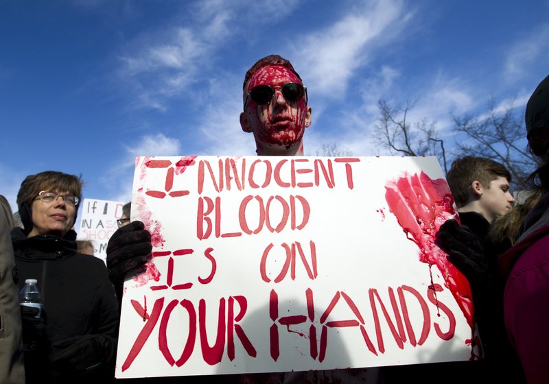 Connor Feliu of Syracuse N.Y., covered in red paint, attends the “March for Our Lives” rally in support of gun control in Washington, Saturday, March 24, 2018, on Pennsylvania Avenue near the U.S. Capitol. (AP Photo/Jose Luis Magana)