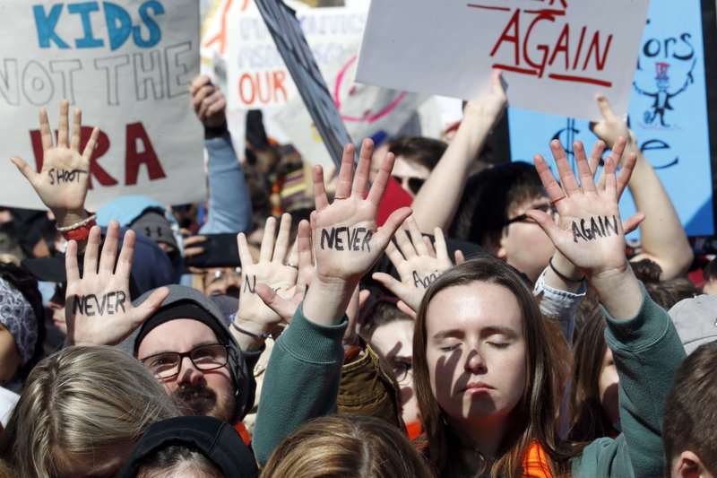 People hold their hands up with messages written on them during the “March for Our Lives” rally in support of gun control, Saturday, March 24, 2018, in Washington. (AP Photo/Alex Brandon)