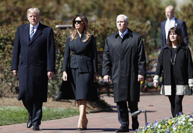 President Donald Trump and First lady Melania Trump, left, and Vice President Mike Pence, and wife Karen Pence arrive ahead of a funeral service at the Billy Graham.