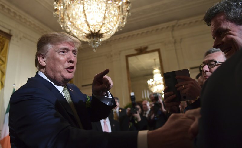 U.S President Donald Trump greets people during a St. Patrick’s Day reception in the East Room of the White House in Washington, Thursday, March 15, 2018. 