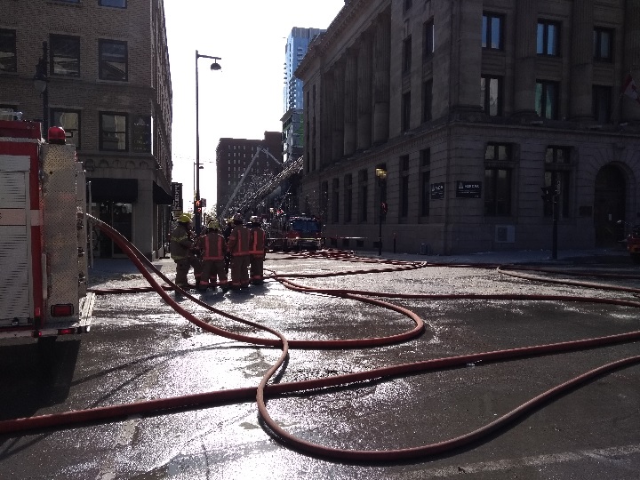 Firefighters still at the scene of Bishop Street fire in downtown Montreal more than six hours after the fire broke out. Saturday, March 24, 2018.