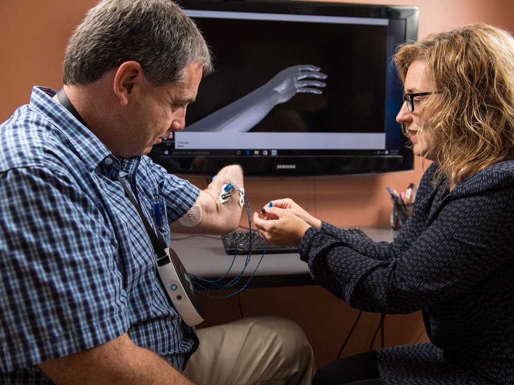 Wendy Hill, a research occupational therapist with the Institute of Biomedical Engineering at the University of New Brunswick (UNB), right, with client Trent Mundie of Fredericton. Hill is one of the researchers at UNB studying whether virtual reality helps ease phantom pain in those that have lost limbs. UNB is first to be holding trials on the potential treatment, for which worldwide clinical testing will be held. 