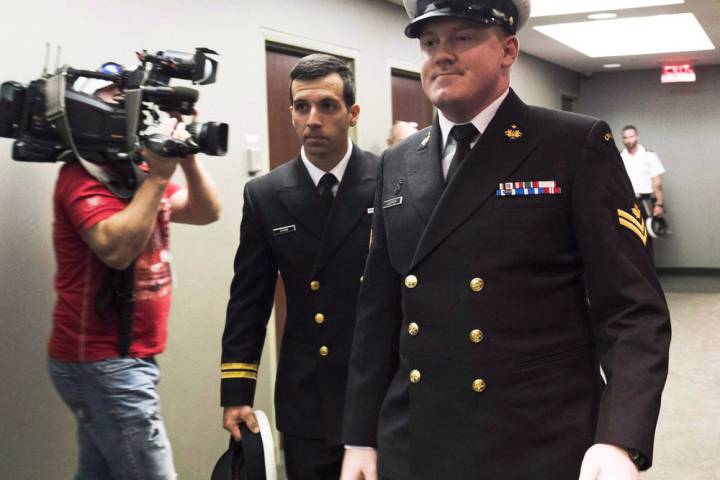FILE - Accused Master Seaman Daniel Cooper, right, arrives for his standing court martial case.
