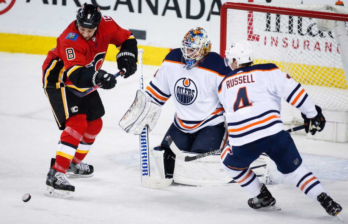 Edmonton Oilers goaltender Cam Talbot (33) and defenseman Kris Russell (4) look on as Calgary Flames right wing Chris Stewart (8) tries for a rebound during second period NHL hockey action in Calgary, Tuesday, March 13, 2018. THE CANADIAN PRESS/Jeff McIntosh.