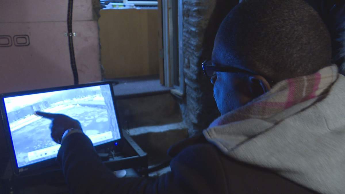 Ariel Jeffrey Kouakou's uncle Charles N'Dakon looks over security footage on March 16, 2018.