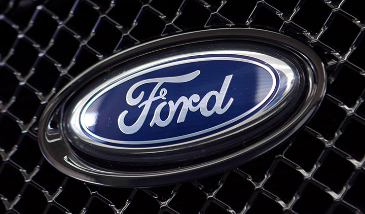 This Aug. 21, 2014 file photo shows the Ford logo on a vehicle at a dealership in Hialeah, Fla.  