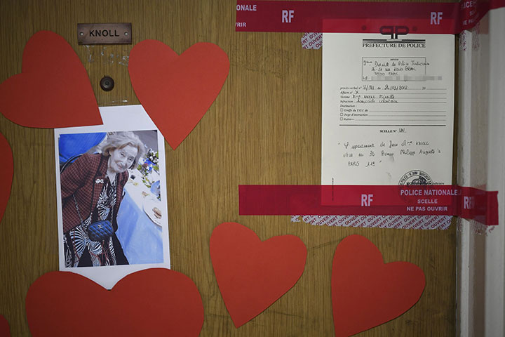 A picture taken on March 27, 2018 shows a photograph of Mireille Knoll, and police documents sealing the door seals to her apartment in Paris.