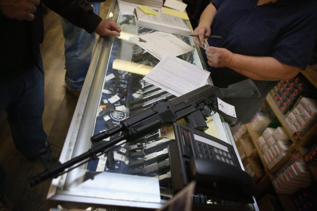 A customer purchases an AK-47 style rifle in Tinley Park, Illinois, Dec. 17, 2012.