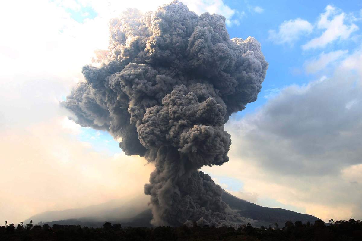Mount Sinabung spews pyroclastic smoke, seen from Tiga Pancur village in Karo district of North Sumatra, Indonesia on October 13, 2014. 