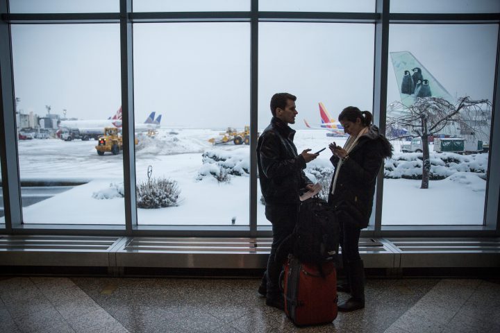 A file photo of travellers at New York's La Guardia Airport.