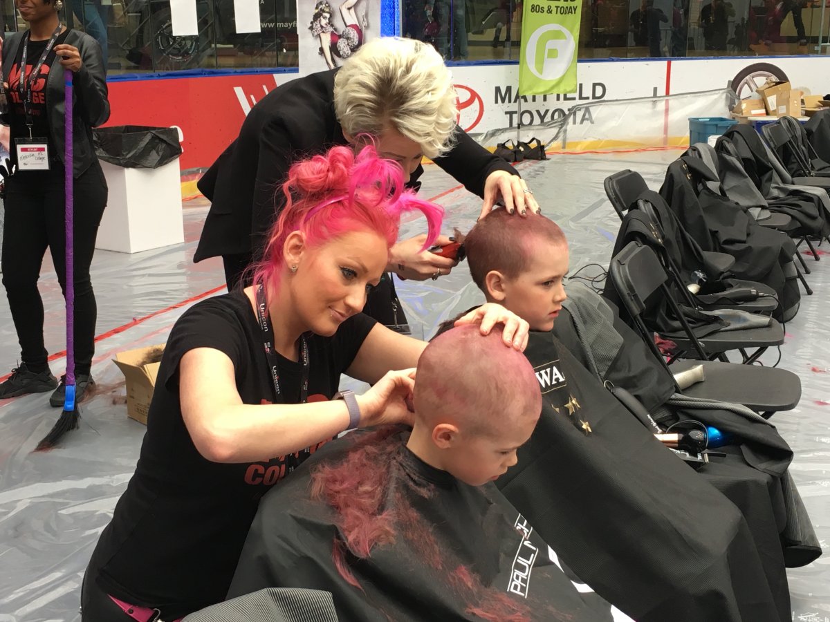 Hockey teammates Oliver and Parker have their pink hair shaved off for cancer.