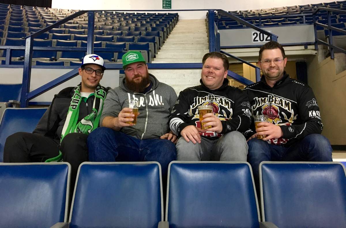 Brent Goeres (right) sips a beer with a few of his buddies at Friday night’s wild card draw in the Brandt Centre before heading to the Patch at the International Trade Centre in Regina, Sask.