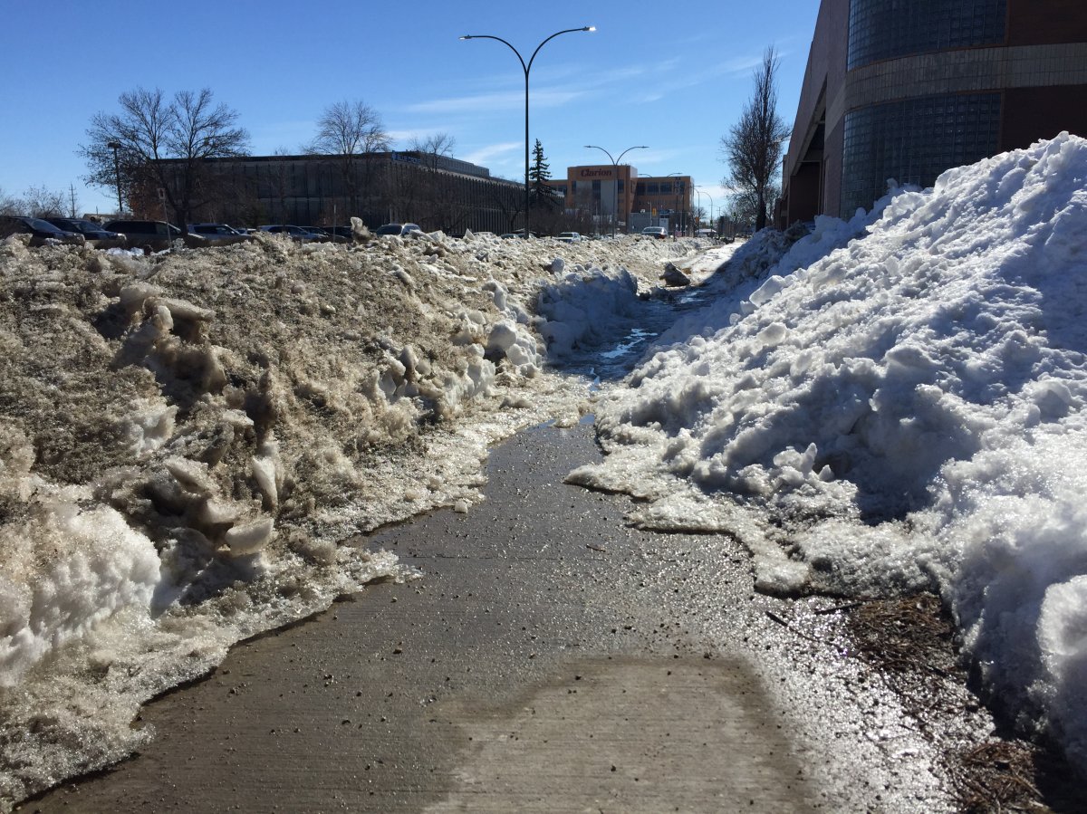 A sidewalk on Empress St. by Polo Park disappears into crowded snowbanks.