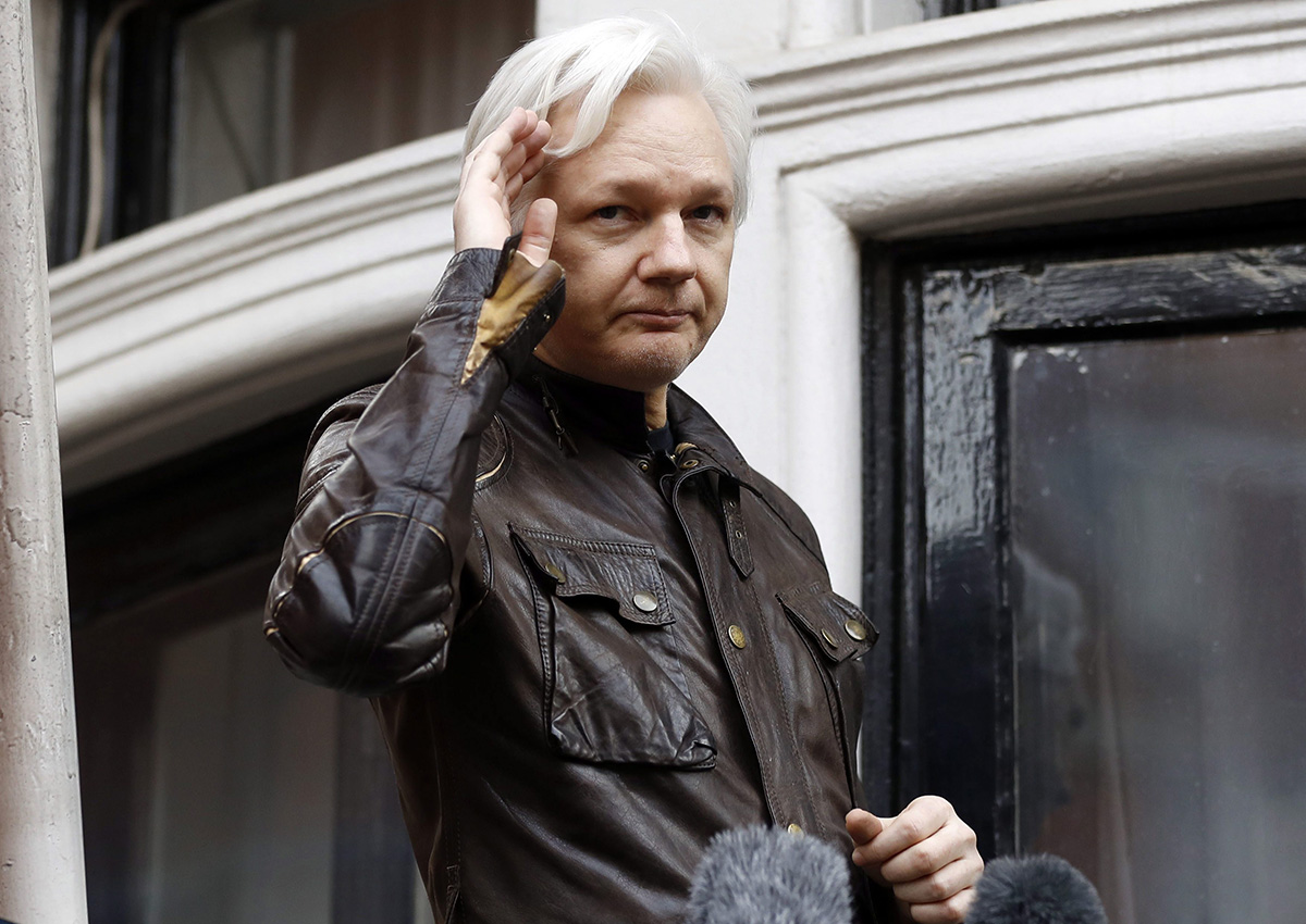 In this May 19, 2017 file photo, WikiLeaks founder Julian Assange greets supporters from a balcony of the Ecuadorian embassy in London.