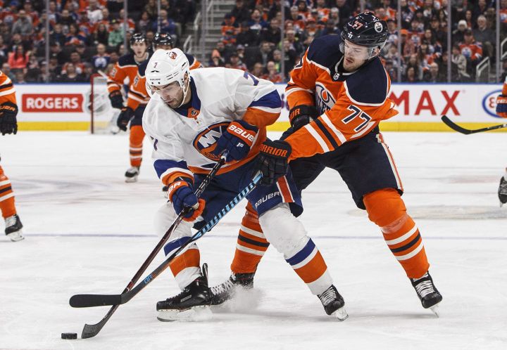 New York Islanders' Jordan Eberle (7) and Edmonton Oilers' Oscar Klefbom (77) battle for the puck during first period NHL action in Edmonton, Alta., on Thursday March 8, 2018. 