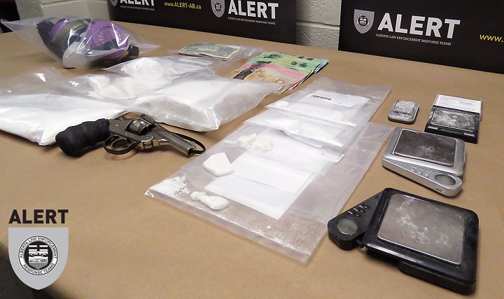 Drugs and weapons police say they seized from a Lethbridge, Alta. apartment on March 27, 2018 are displayed.