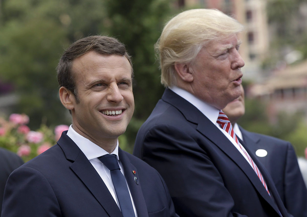 In this May 26, 2017 file photo French President Emmanuel Macron smiles as he stands beside U.S. President Donald Trump in Taormina, Italy.