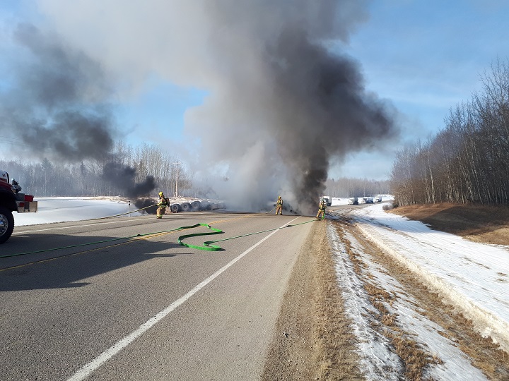 Emergency crews were called to a vehicle fire after a truck hauling lumber rolled near Breton, Alta. on March 14, 2018.