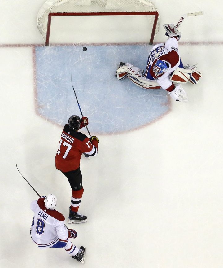 New Jersey Devils left wing Patrick Maroon (17) scores a goal on Montreal Canadiens goaltender Charlie Lindgren (39) as defenseman Jordie Benn (8) looks on during the second period of an NHL hockey game, Tuesday, March 6, 2018, in Newark, N.J. The Devils won 6-4.