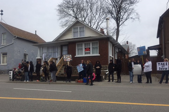 Family and friends of Rori Hache gathered on Friday to demand the house at 19 McMillian Drive be torn down.