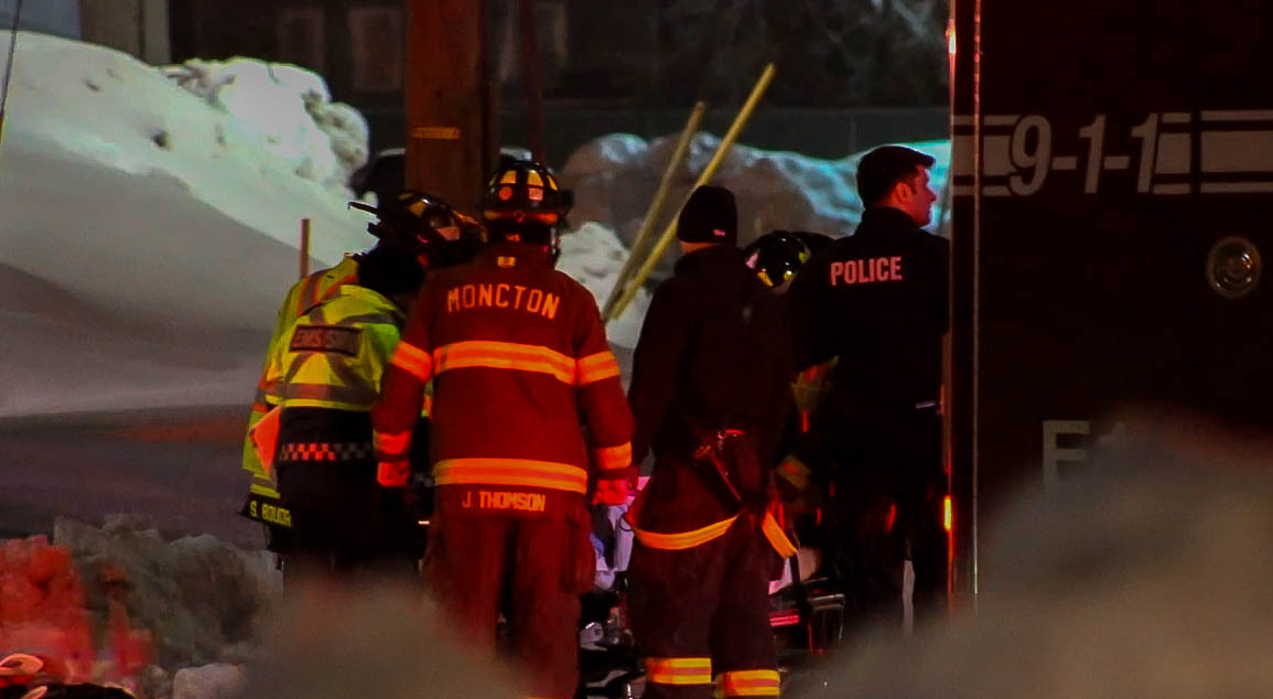Members of Moncton Fire, Codiac District RCMP and Ambulance New Brunswick attend to an injured man in the early morning of March 11, 2018. 