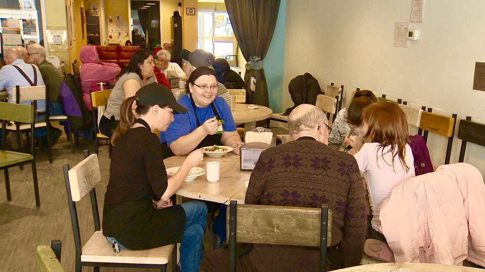 Marsha Barber and community members share a meal at NorWest Co-op Community Food Centre in Winnipeg.