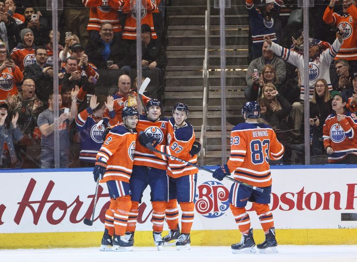 Edmonton Oilers' Andrej Sekera (2), Milan Lucic (27), Connor McDavid (97) and Matthew Benning (83) celebrate a goal against the Arizona Coyotes during first period NHL action in Edmonton, Alta., on Monday March 5, 2018. 