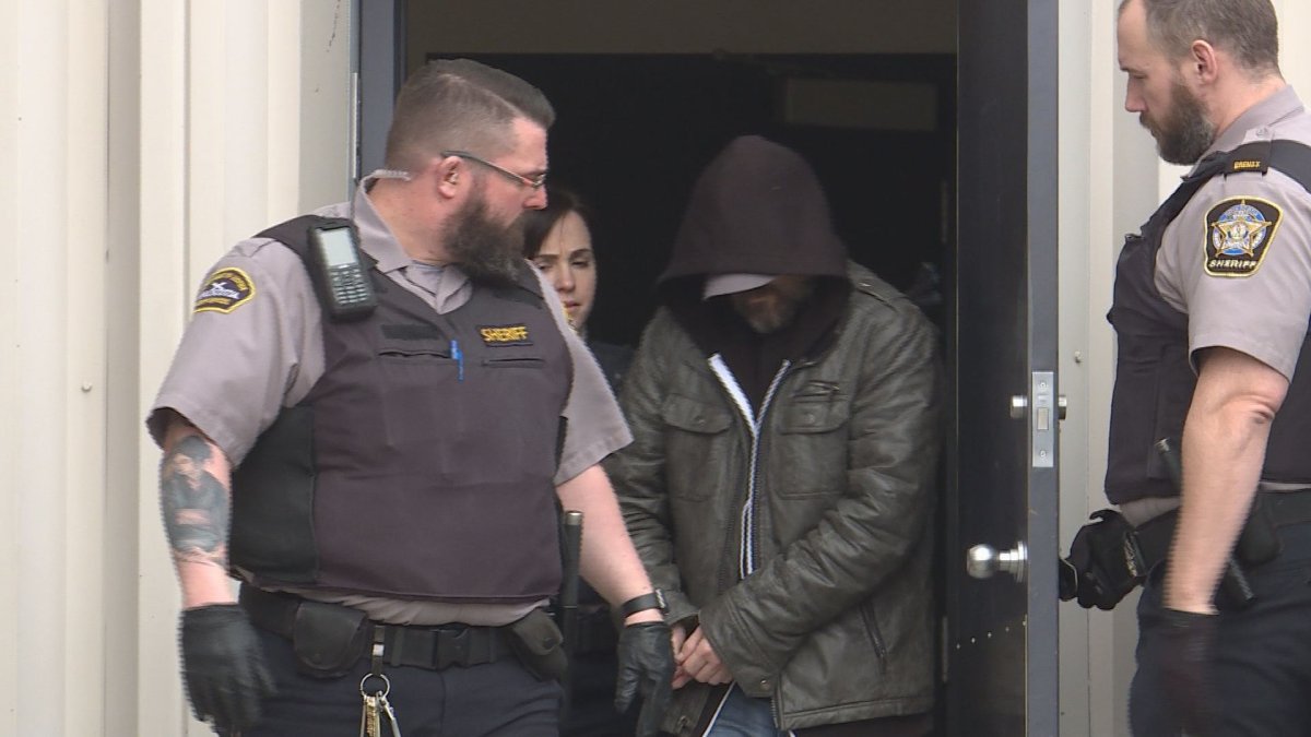Owen Patrick Nelson is led from court last week in Dartmouth, after being charged with interfering with the remains of Karen MacKenzie. Her body has not been located. 