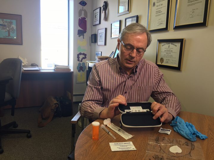 Dr. Peter Butt demonstrates a naloxone kit and said administering it when in doubt is best as the medicine causes no harm if used unnecessarily.