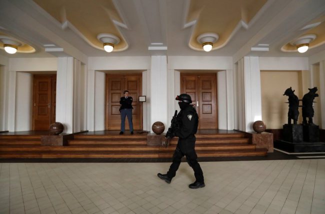 A prison guard walks outside a courtroom during an appeal by Yevgeniy Nikulin in Prague, Czech Republic, Nov. 24, 2017.