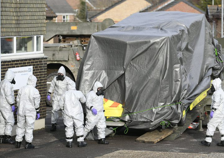 Members of the armed forces in protective suits remove an ambulance from the Salisbury ambulance station in Salisbury, Britain.