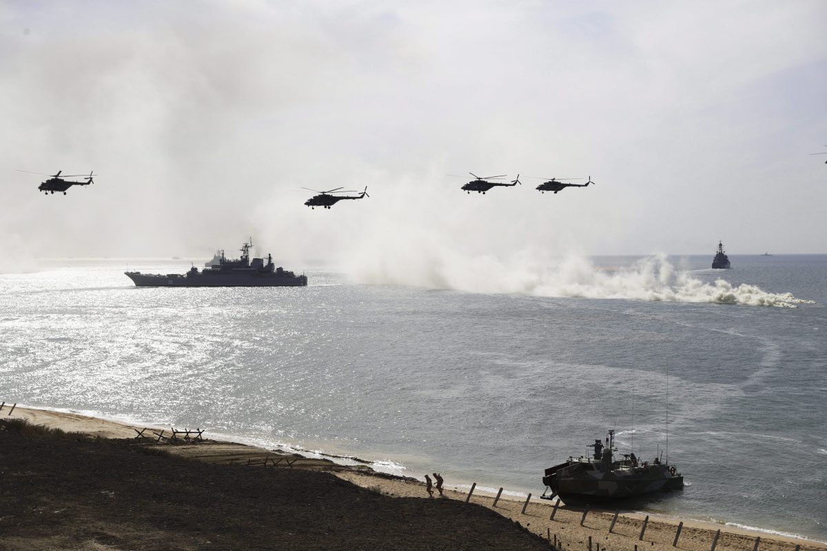 In this file photo taken on Friday, Sept. 9, 2016 Russian navy ships and helicopters take a part in a landing operation during military drills at the Black Sea coast, Crimea.  (AP Photo/Pavel Golovkin, File).