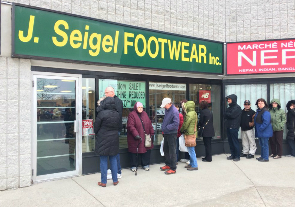 A line of people wait to get inside J. Seigel Footwear on Mar. 1, 2018. The store has been in operation at Highbury Avenue and Huron Street since 1998.