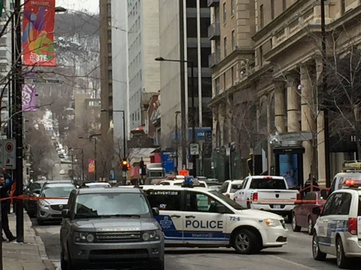 Police close off Peel Street after shots were fired at a luxury clothing store in downtown Montreal.